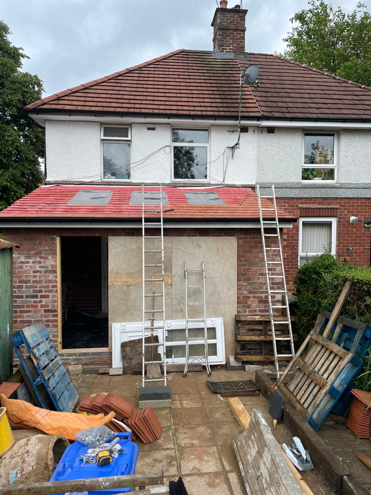 Rear extension under construction with unfinished garden paving