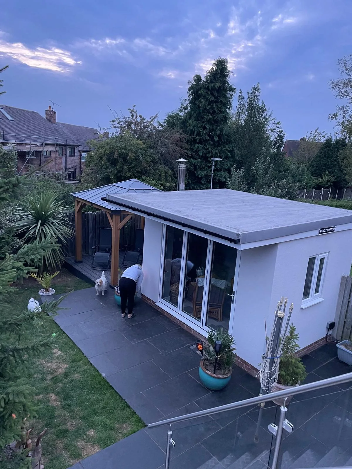 Completed white garden room with glazed doors viewed from the garden