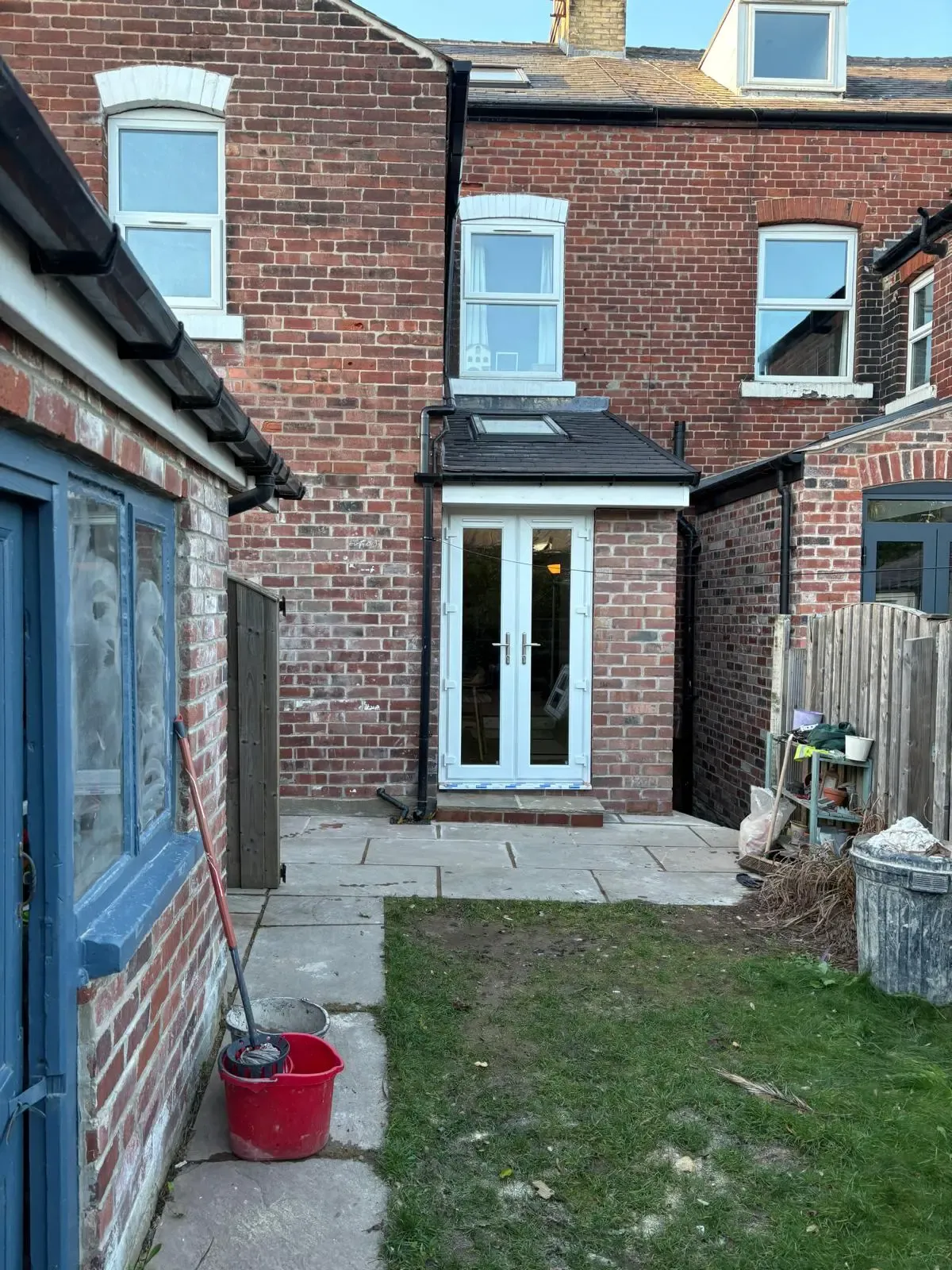 Brick rear extension with tiled roof, rooflight and French doors onto a new patio