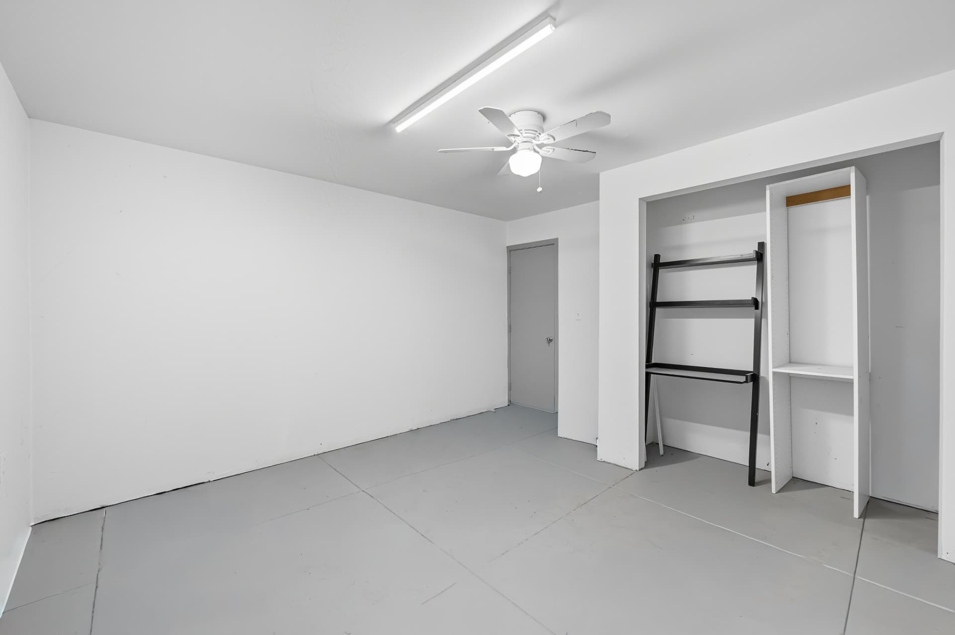 Garage conversion interior with white walls and built-in storage