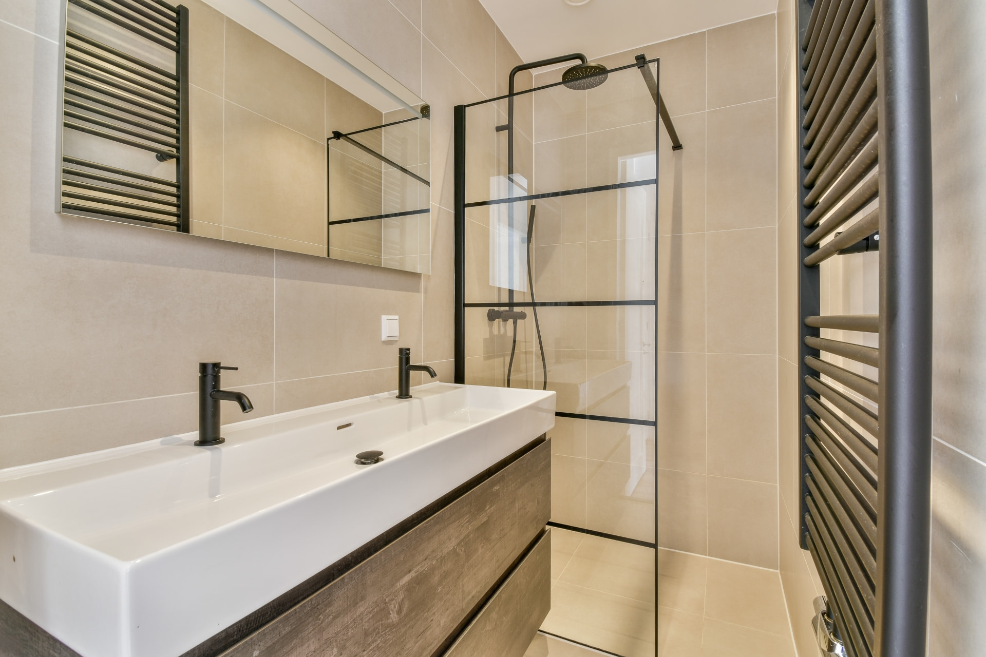 Bathroom with a double basin, glass shower screen and black fittings