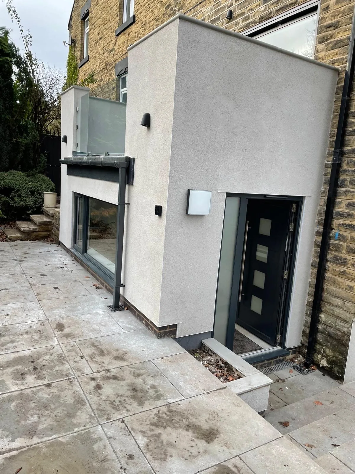 Contemporary rendered extension with tall corner glazing