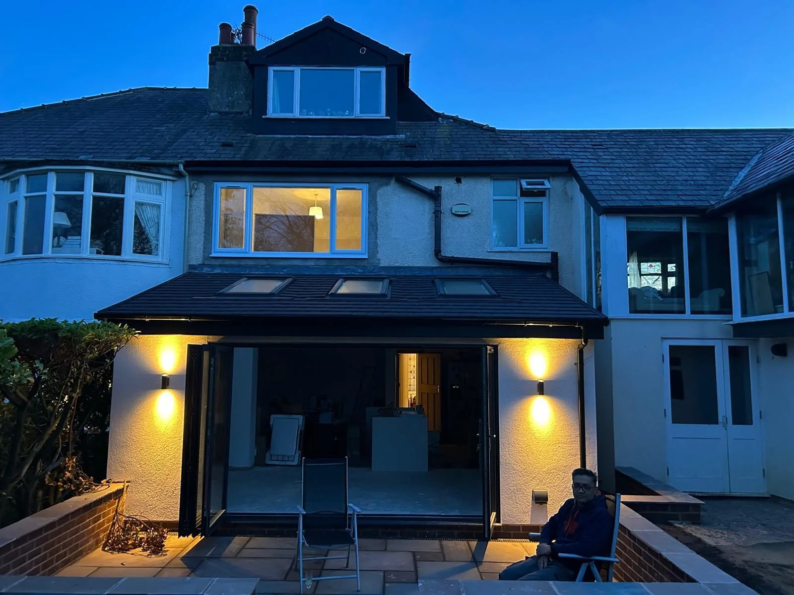 Illuminated rear extension with rooflights photographed at dusk